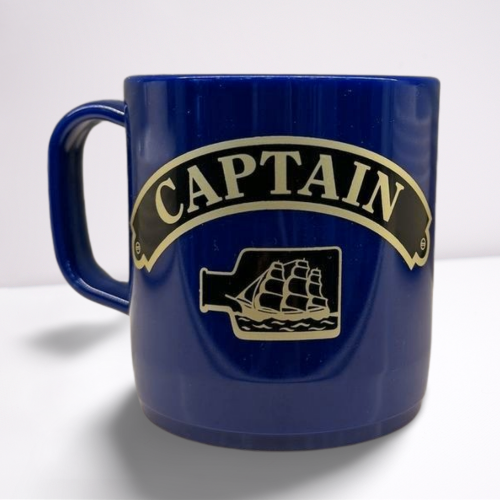 Royal Blue unbreakable mug, featuring black and gold accents of the word captain and a ship in a bottle.