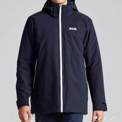 Person wearing a navy blue jacket with a brand logo on a gray background