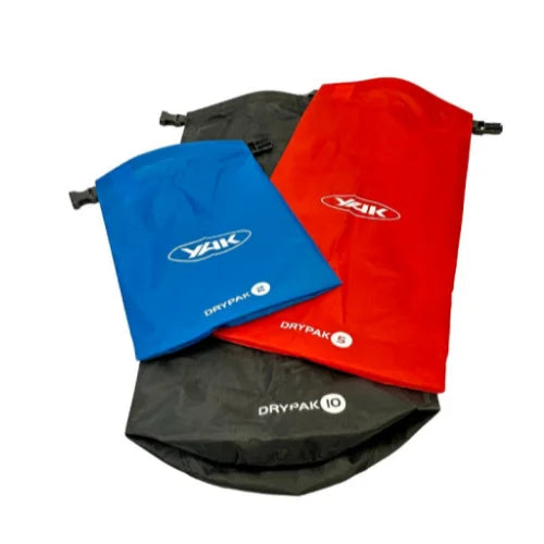 A set of three Yak Drypak Ripstop Drybags in blue, black, and red colors, with the Yak logo on the front.