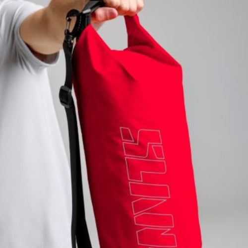 Red bag with 'Slam' branding held by a person against a gray background