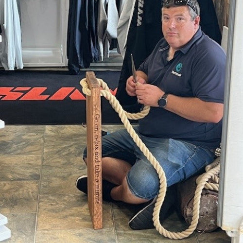 Man working with rope in a store setting
