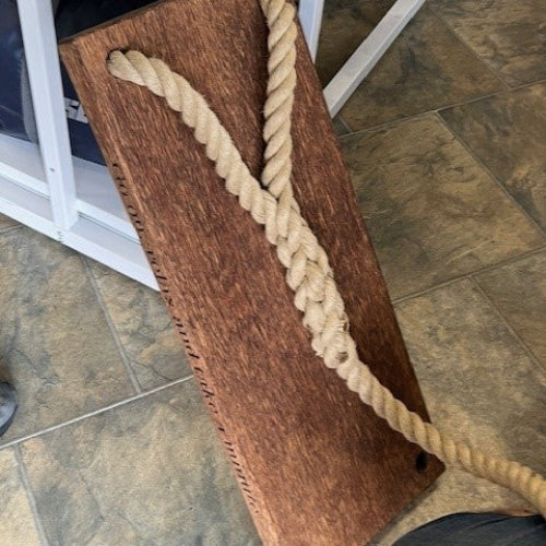 Wooden board with a rope on a tiled floor