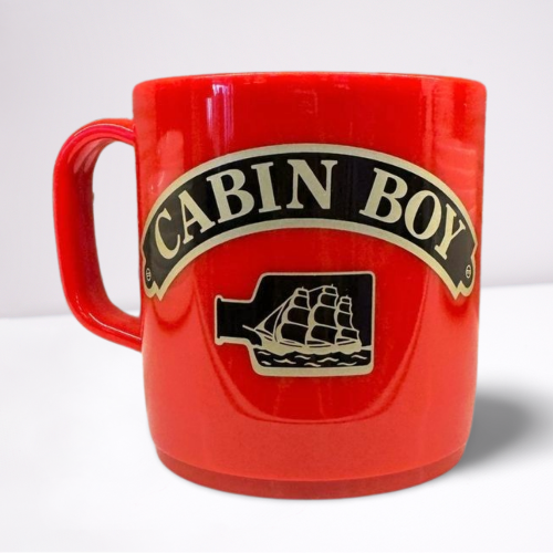 Red unbreakable mug, featuring black and gold accents of the words cabin boy and a ship in a bottle.