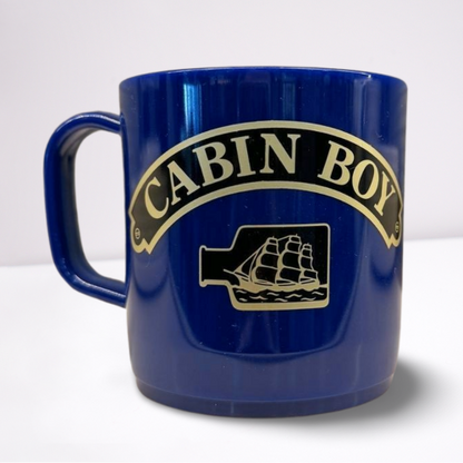 Royal Blue unbreakable mug, featuring black and gold accents of the words cabin boy and a ship in a bottle.