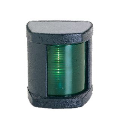 Green navigation light with black casing on a white background