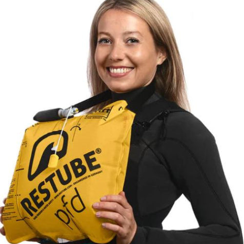 Person holding a yellow RESTUBE product on a white background