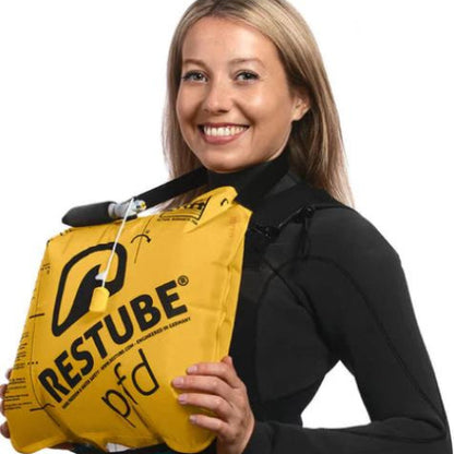 Person holding a yellow RESTUBE product on a white background