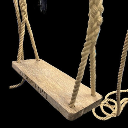 Wooden swing with ropes in a storage or workshop setting