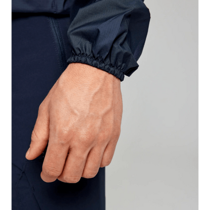 Water-repellent SLAM ACT Packlite Jacket with spacious side pockets and adjustable hood for outdoor activities.